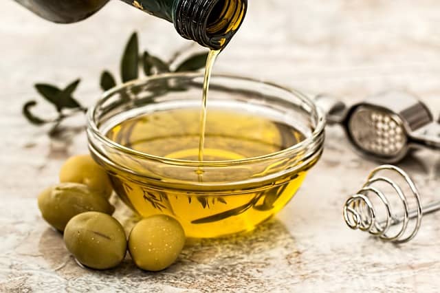 pouring olive oil into bowl